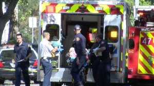 A person is placed in an ambulance as deputies conduct what officials described as a "burglary investigation" in a neighborhood in the unincorporated county area of East Pasadena on April 17, 2019. (Credit: RMG News)
