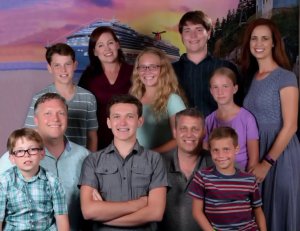 Robert Ellis, in the solid blue shirt at bottom left, is seen with his wife (in the maroon shirt), their children and his brother's family in an undated photo provided by relatives.