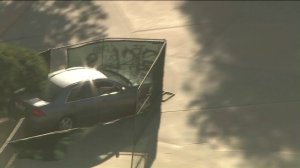 The vehicle is seen crashing through a chain link fence in the Florence-Firestone unincorporated area of South Los Angeles on April 24, 2019. (Credit: KTLA)