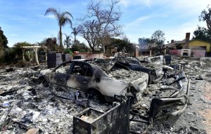 The remains of burnt down homes and vehicles are seen after the Woolsey Fire in Malibu on Nov. 13, 2018. (Credit: FREDERIC J. BROWN/AFP/Getty Images)