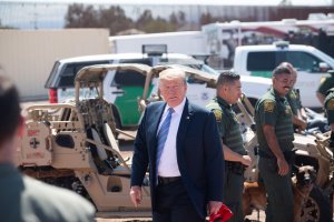 President Donald Trump speaks with members of the U.S. Border Patrol as he tours the border wall between the U.S. and Mexico in Calexico on April 5, 2019. (Credit: Saul Loeb / AFP / Getty Images)