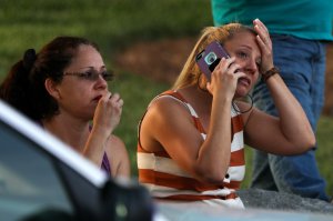 Family members and friends wait for their loved ones at a staging area after a shooting on the campus of University of North Carolina Charlotte in University City, Charlotte, on April 30, 2019. (Credit: LOGAN CYRUS/AFP/Getty Images)