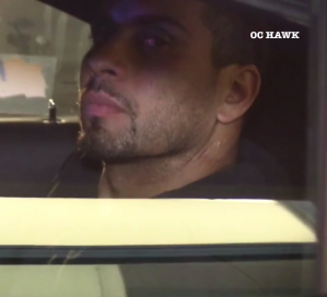 The pursuit suspect is seen after his arrest in sitting in the back of a patrol car in Rowland Heights on April 24, 2019.