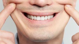 A person is seen smiling in this file image. (Credit: Shutterstock)