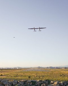 The Stratolaunch, the world's largest plane, flies alongside another aircraft over the Mojave Desert on April 13, 2019. (Credit: Stratolaunch)