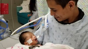 Yovany Lopez holds his son. (Credit: Cecila Garcia)