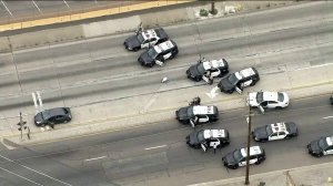Police cars surround a vehicle after a pursuit on May 10, 2019 in Vernon. (Credit: KTLA)