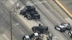 Armored vehicles surround the suspect's car in Vernon on May 10, 2019. (Credit: KTLA)