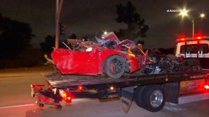 The mangled wreck of a totaled Lamborghini was hauled away by a tow truck on May 16, 2019. (Credit: AMG News)