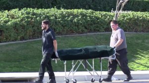 Officers transport the victim's body that was found on a Corona street on Feb. 7, 2018. (Credit: InlandNews)