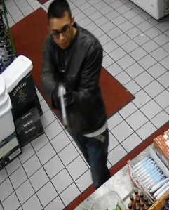 The gunman sought in the killing of a Downey convenience store clerk is seen in a still from surveillance video captured by the store’s cameras and released by Downey police on May 9, 2019.