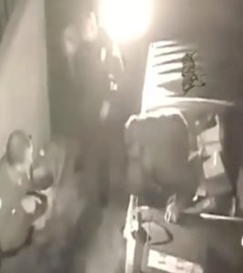 This still from footage released by the Garden Grove Police Department on May 13, 2019, shows a man hiding from officers inside a dumpster.