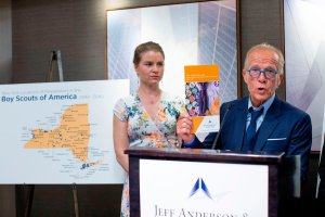 Bridie Farrell (L), a survivor of abuse and co-founder of NY Loves Kids, listens to victims' rights Attorney Jeff Anderson (L) as he speaks at a press conference on April 23, 2019, in New York. Anderson discussed allegations of child abuse against the Boys Scouts of America (BSA) which were reported April 22, 2019. The accusations were revealed and the names of some 130 of the alleged abusers were to be released. Anderson claims the BSA has files on abusers dating to the 1940s. (Credit: EDUARDO MUNOZ ALVAREZ/AFP/Getty Images)