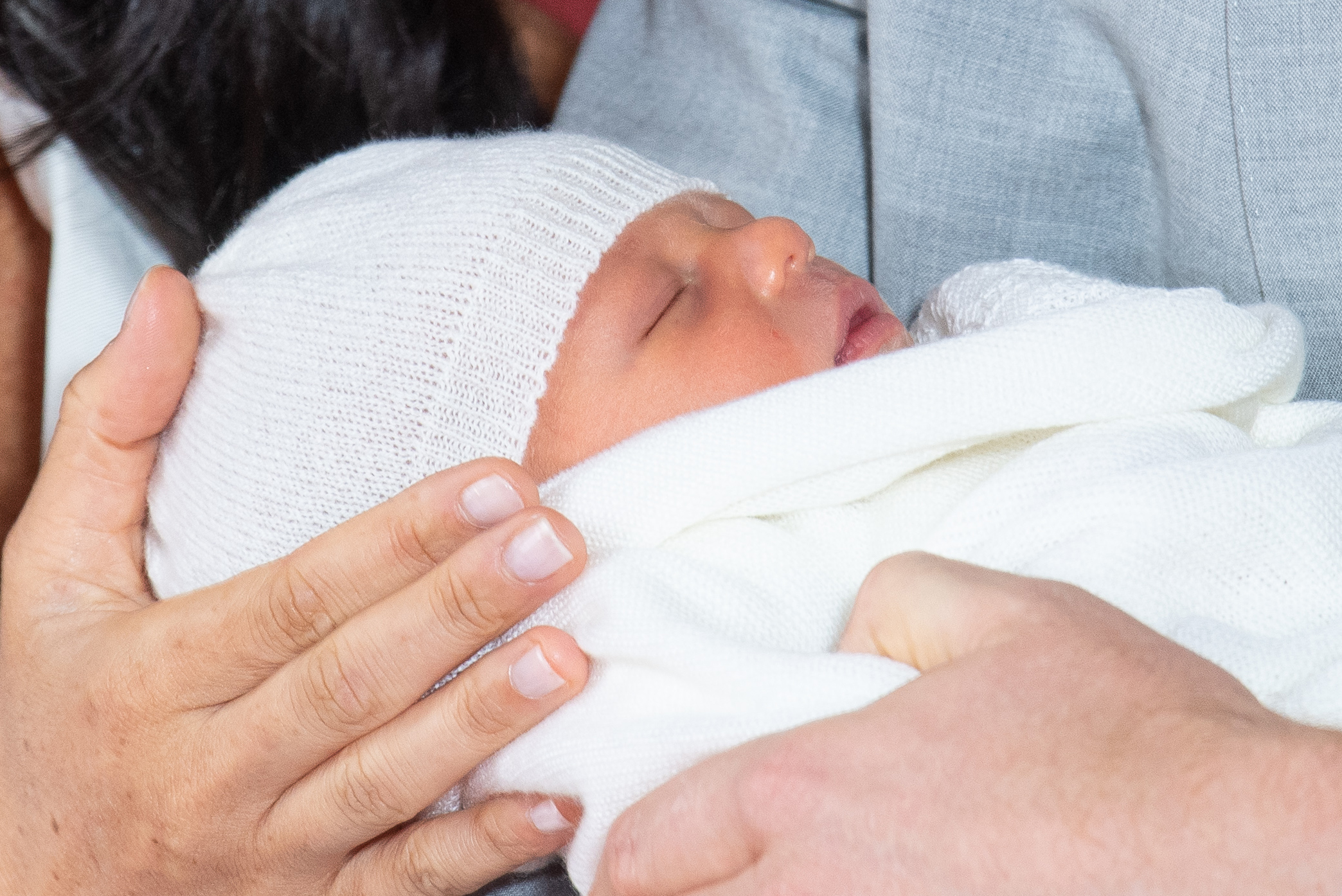 Britain's Prince Harry, Duke of Sussex (R), and his wife Meghan, Duchess of Sussex, pose for a photo with their newborn baby son in St George's Hall at Windsor Castle in Windsor, west of London on May 8, 2019. (Credit: DOMINIC LIPINSKI/AFP/Getty Images)
