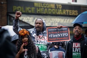 People protest outside the police headquarters while a disciplinary hearing takes place for officer Daniel Pantaleo on May 13, 2019, in New York City. (Credit: Kena Betancur / AFP / Getty Images)