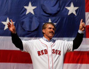 Former Boston Red Sox player Bill Buckner acknowledges the cheers from the crowd before throwing out the ceremonial first pitch at the MLB baseball game between the Boston Red Sox and Detroit Tigers on April 8, 2008 at Fenway Park in Boston, Massachusetts. (Credit: Brian Snyder-Pool/Getty Images)