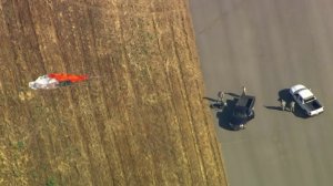 A parachute is seen in a field after a F-16 pilot ejected just before a crash near March Air Reserve Base in Riverside County on May 16, 2019. (Credit: KTLA)