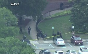 Officers are seen at the site of a shooting at a Virginia Beach municipal center that left at least 11 people dead on May 31, 2019. (Credit: WAVY)