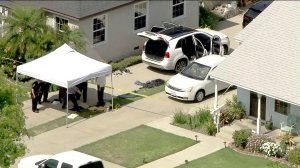 Officials inspect materials from the suspect's vehicle in Long Beach as seen in this image from Sky5 on June 11, 2019. (Credit: KTLA)