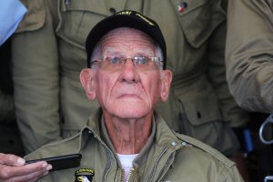 WWII veteran Tom Rice of San Diego speaks to the press after taking part in a parachute drop over Carentan, Normandy, on June 5, 2019, as part of D-Day commemorations marking the 75th anniversary of the World War II Allied landings in Normandy. (Credit: Ludovic Marin / AFP / Getty Images)