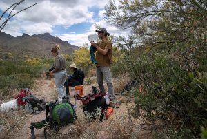 Scott Warren, a volunteer for the humanitarian aid organization No More Deaths pauses while delivering food and water along remote desert trails used by undocumented immigrants on May 10, 2019, near Ajo, Arizona. (Credit: John Moore/Getty Images)