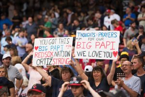 Fans hold up signs showing support for former Red Sox player David Ortiz prior to the start of the game against the Texas Rangers at Fenway Park on June 10, 2019 in Boston, Massachusetts. (Credit: Kathryn Riley /Getty Images)