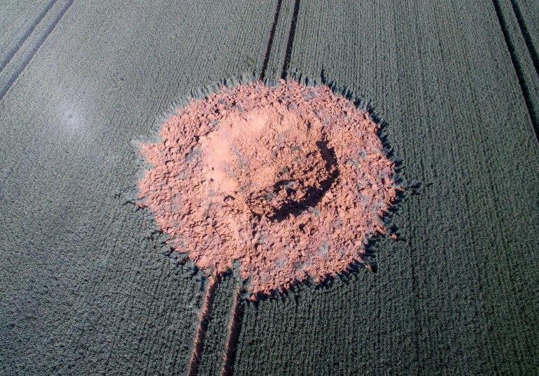 An aerial view shows a crater on a barley field near Ahlbach, on June 24, 2019. (Credit: BORIS ROESSLER/AFP/Getty Images)