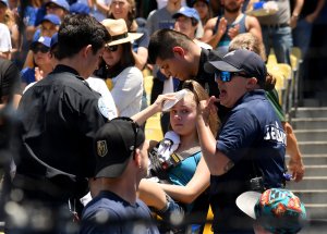 Kaitlyn Salazar is escorted on a stretcher after she was hit by a foul ball off the bat of Cody Bellinger on June 23. (Credit: Harry How/Getty Images)