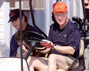 Tony Rodham rides a golf cart with Bill Clinton at Maple Run Golf Course in Thurmont, Maryland on Aug. 14, 1999. (Credit: STEPHEN JAFFE/AFP/Getty Images)