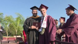 Alexander Harris, who is recovering from a broken neck, stepped out of his wheelchair to accept his diploma at Claremont High School on June 13, 2019. (Credit: KTLA)