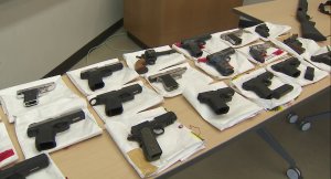 Guns seized during a two-year investigation into a San Pedro gang are shown on June 26, 2019. (Credit: KTLA)