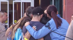 Family and friends of slain Los Angeles County Sheriff’s Deputy Joseph Gilbert Solano embrace each other following a press conference announcing his death on June 12, 2019. (Credit: KTLA)