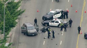 A SUV and a badly damaged LAPD motorcycle are shown at the scene of a crash in Van Nuys on June 14, 2019. (Credit: KTLA)