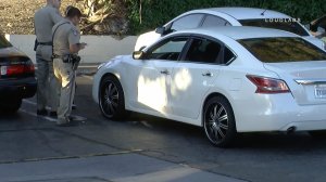 California Highway Patrols officers examine bullet holes in a car following a shooting on the 10 Freeway in Pomona on June 28, 2019. (Credit: Loudlabs)