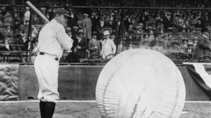 Baseball player Babe Ruth (George Herman Ruth, 1895 - 1948) taking a swipe at an enormous ball. (Credit: Fox Photos/Getty Images)