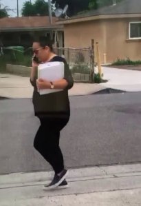 A woman being sought after allegedly posing as a social work in a kidnapping attempt in Santa Ana is seen in a still from a video released by Santa Ana police on June 7, 2019.