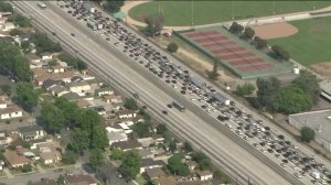 Traffic backed up for miles on the westbound 10 Freeway as a Los Angeles County Sheriff's Department SWAT team deals with an armed, barricaded suspect in San Gabriel on June 6, 2019.