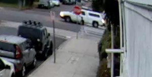 A white pickup with a camper shell is seen as it runs over an elderly man in a Valley Village crosswalk on June 17, 2019, in a still from surveillance video provided by the victim’s family.