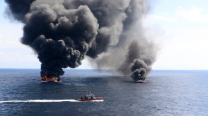 Crew members from the U.S. Coast Guard Cutter Monro aboard a 35-foot long range interceptor boat supervise the intentional sinking of suspected drug-smuggling boats after seizing cocaine from them in the waters of the Eastern Pacific Ocean on May 17, 2019. (Credit: USCG)