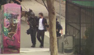 Authorities detain Robert Camou after an hourslong standoff in downtown Los Angeles on July 30, 2019. (Credit: KTLA)