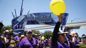 Disneyland workers and supporters march while protesting low pay and calling for a living wage at the Disneyland entrance on July 3, 2018 in Anaheim. (Credit: Mario Tama/Getty Images)