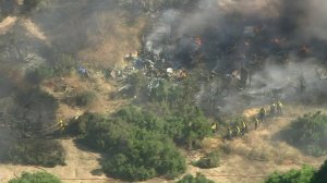 Firefighters respond to a homeless encampment during a brush fire in the Sepulveda Basin on July 30, 2019. (Credit: KTLA)