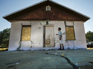 Jenner Kim of Trona examines his storage building, which was badly damaged by the Fourth of July quake in 2019. (Credit: Irfan Khan / Los Angeles Times)