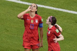 Alex Morgan, left, is congratulated by teammates after scoring a goal during the France 2019 Women's World Cup semi-final football match between England and USA, on July 2, 2019, at the Lyon Satdium in Decines-Charpieu, central-eastern France. (Credit: JEAN-PHILIPPE KSIAZEK/AFP/Getty Images)