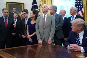 Apollo 11 astronaut Michael Collins (center) listens to NASA Administrator Jim Bridenstine (left) answer questions from U.S. President Donald Trump as they commemorate the 50th anniversary of the moon landing in the Oval Office at the White House, July 19, 2019, in Washington, D.C. (Credit: Chip Somodevilla/Getty Images)