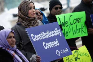 Zainab Chaudry (center) joins other supporters from The Council on American-Islamic Relations during a news conference outside the U.S. Supreme Court after the court heard oral arguments in EEOC v. Abercrombie & Fitch Feb. 25, 2015, in Washington, D.C. Samantha Elauf of Tulsa, Okla., filed a charge of religious discrimination with the Equal Employment Opportunity Commission saying Abercrombie & Fitch violated discrimination laws in 2008 by declining to hire her because she wore a head scarf, a custom of her Muslim faith. (Credit: Chip Somodevilla/Getty Images)