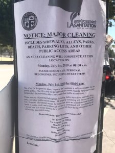 A flier posted on a pole in downtown Los Angeles announces a clean up on July 1, 2019. (Credit: KTLA)