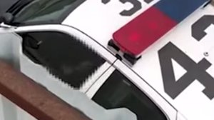 What appears to be a sex act being performed in a patrol car in Santa Ana is seen in a video posted to Youtube by O.C. Weekly on July 18, 2019. (Credit: O.C. Weekly)