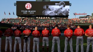 The Los Angeles Angels of Anaheim stand for a moment of silence before they play the Seattle Mariners at Angel Stadium of Anaheim on July 12, 2019 in Anaheim, California. The entire Angels team wore #45 on their jersey to honor Skaggs who died on July 1. (Credit: John McCoy/Getty Images)