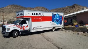 A U-Haul truck appears on a driveway in Trona where some residents are packing their belongings on July 8, 2019. (Credit: KTLA)